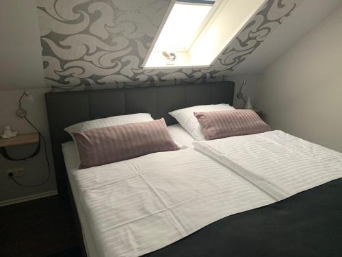 a bedroom with two beds and a skylight at Haus-Encore-Wohnung-4 in Büsum