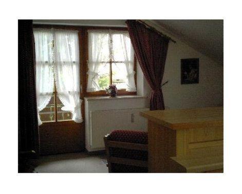 a living room with two windows and a table at Haus-Alphorn-Wohnung-15 in Oberstdorf