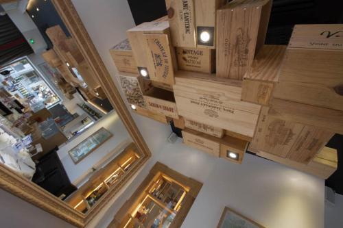 a room with boxes on the wall and a mirror at Hôtel et Spa La Villa K - Basel Airport in Saint-Louis