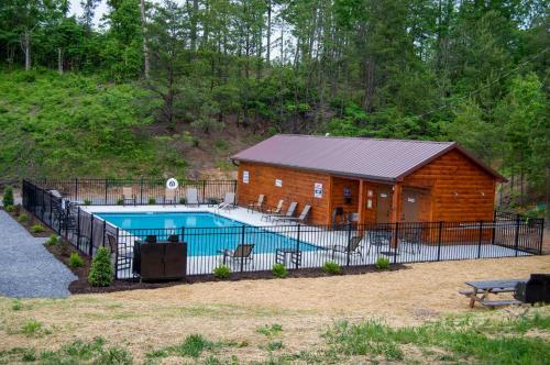 a log cabin with a pool in front of it at A View from the Top in Sevierville