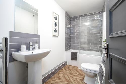 a bathroom with a sink and a toilet at The Penthouses, 8 Albion Mews in Chester