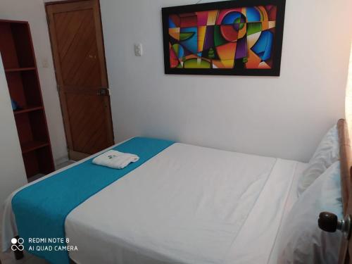 a bedroom with a bed with a painting on the wall at Hotel Las Vegas by CMS hotels in Santa Marta
