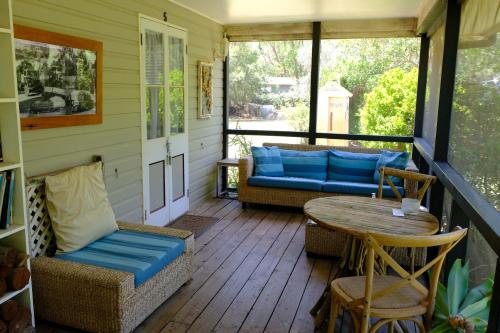 a screened in porch with a table and chairs at The Laurels of Chinchilla in Chinchilla