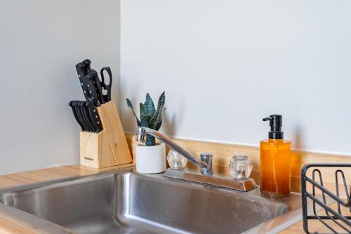 a kitchen sink with utensils on a counter at Walker's Paradise 1BR Apartment in Lincoln Park - Lincoln 2501 in Chicago