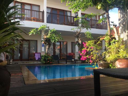 a swimming pool in front of a building at Amed Sunset Beach in Amed