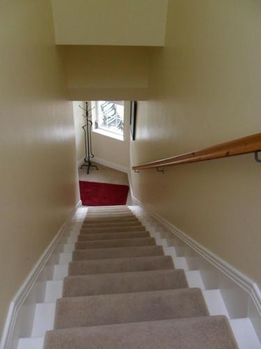 a staircase in a building with a stair case at Croi an Bháile Luxury Apartment in Rosscarbery