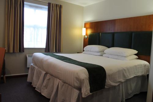 a bedroom with a large bed in a hotel room at The Villa Express in Kirkham