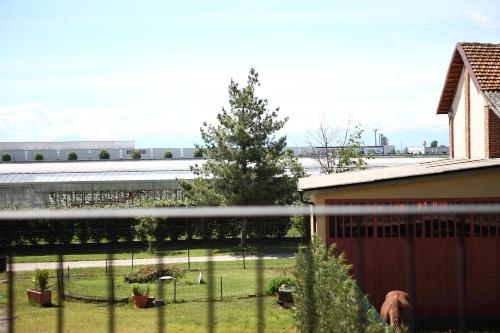 a fence in front of a building with a yard at Al Casale B&B in Cherasco