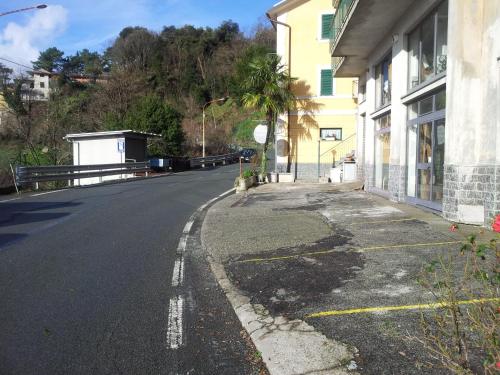 an empty street next to a building on a hill at Locanda Bell'Aria in Uscio