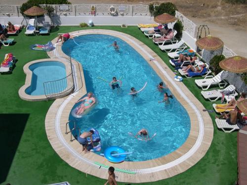 a group of people in a pool at a resort at Ozukara Apart 1 in Gümbet