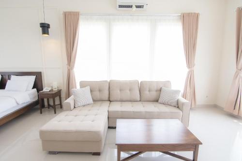 a living room with a couch and a coffee table at Sevilla Resort Magelang in Magelang
