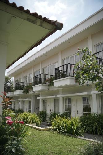 an apartment building with balconies and plants at Sevilla Resort Magelang in Magelang