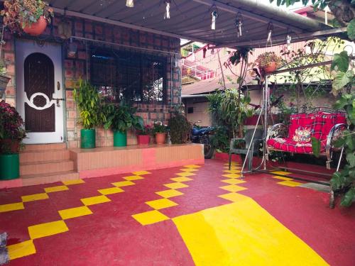 a house with a carpet with yellow arrows on it at Om Datta Krupa Niwas Cottage in Mahabaleshwar
