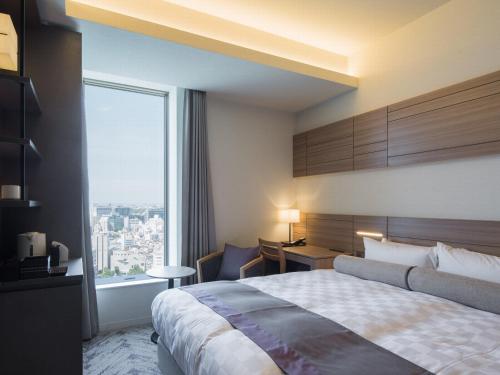 מיטה או מיטות בחדר ב-Nihon Seinenkan Hotel