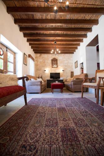 a living room with couches and a large rug at DROUSHIA CORNER HOUSE in Drousha