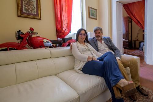 a man and a woman sitting on a couch at Dimora San Leucio in Lecce