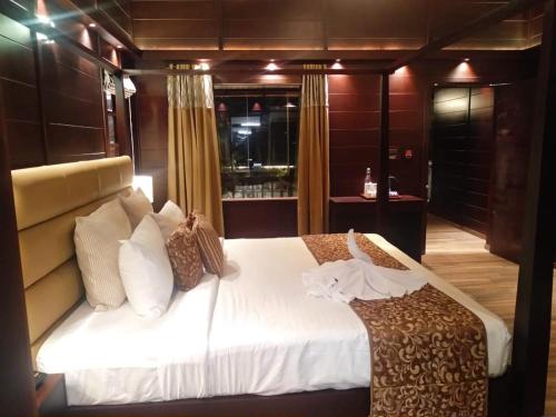 a bedroom with a large bed in a room at Maliekal Heritance Cherai Beach Cochin in Cherai Beach