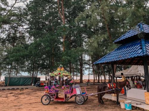 a purple horse drawn carriage with a horse pulling it at Arni Homestay - Geliga in Cukai