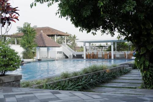 a swimming pool in the middle of a house at Sevilla Resort Magelang in Magelang