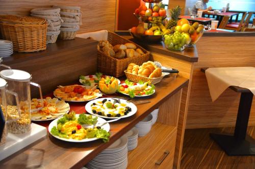 a buffet with several plates of food on a table at Hotel Harburger Hof in Hamburg