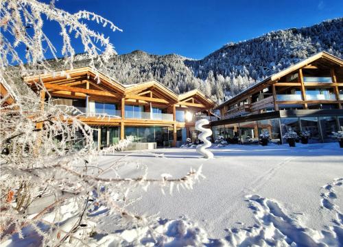 a lodge in the snow with snow covered trees at Au Club Alpin in Champex