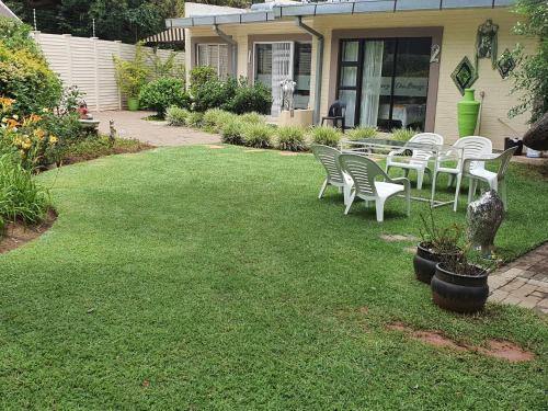 a group of chairs and a table on a lawn at Chic Breeze in Bloemfontein