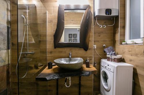 a bathroom with a sink and a washing machine at "34" Apartment in Belgrade