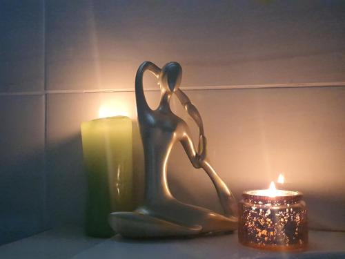 a statue of a woman next to a candle at Chic Breeze in Bloemfontein