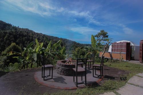 a group of chairs sitting next to a fire pit at Moondock Luxury Camp in Munduk