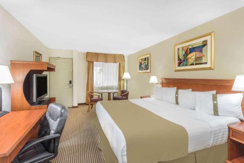 a hotel room with a large bed and a desk at Wyndham Garden Obregon in Ciudad Obregón
