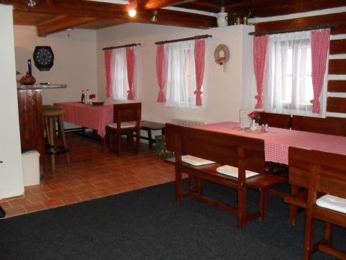 a dining room with pink tables and chairs at Penzion Pampeliška in Pec pod Sněžkou
