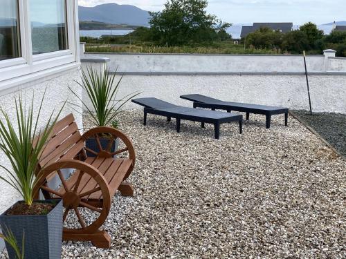 a couple of benches sitting next to a building at Skerrols in Broadford