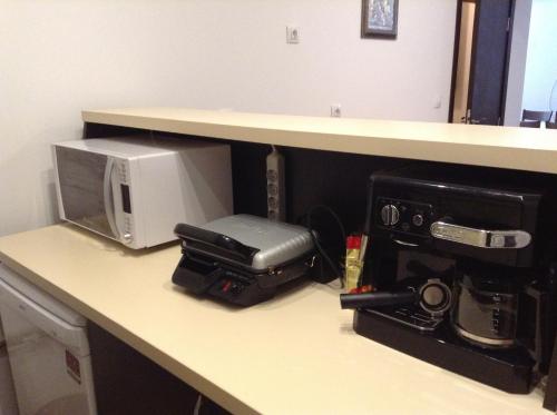 a desk with a microwave and a printer on it at Guest House Luchi in Varshets