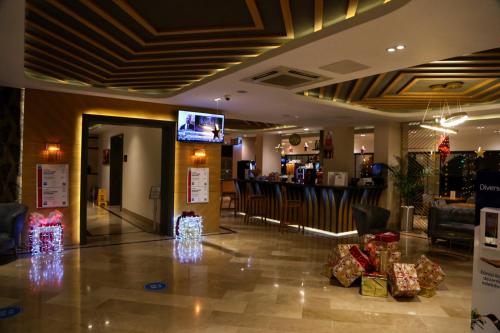 a lobby with christmas presents and a bar at Sealife Lounge - Adult only in Antalya