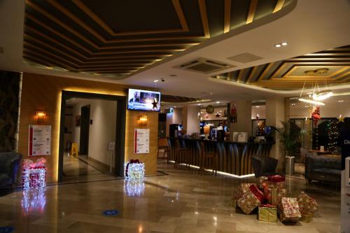 un vestíbulo con regalos de Navidad en el suelo y un bar en Sealife Lounge - Adult only, en Antalya