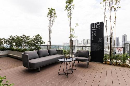 a couch and two chairs on top of a building at 9am-5pm, SAME DAY CHECK IN AND CHECK OUT, Work from Home, Comfy & Quiet Tamarind Suites-Cyberjaya by Flexihome-MY, in Cyberjaya