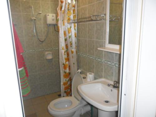 a small bathroom with a toilet and a sink at Sunway Residence in Mont Choisy