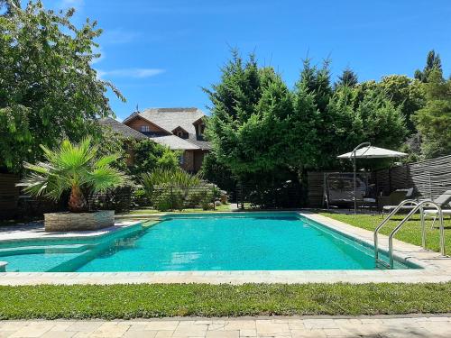 a swimming pool in the backyard of a house at Hotel Malalhue in Pucón