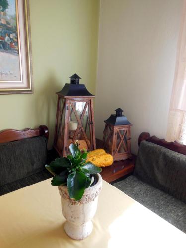 a living room with a vase with a plant on a table at Gorgiani in Spercheiada