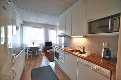 a kitchen with a sink and a counter top at JK Apartment Jannela in Lapua