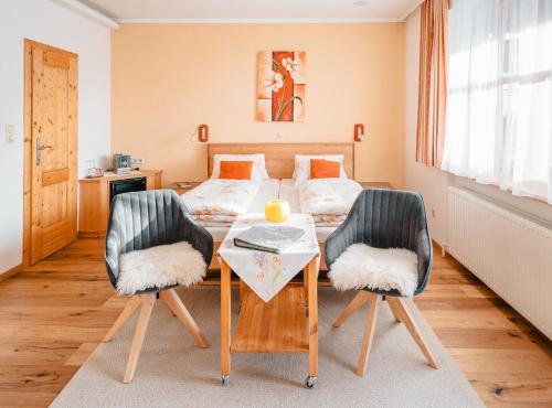 a bedroom with a bed and a table with two chairs at Prinzenhof in Grossgerungs
