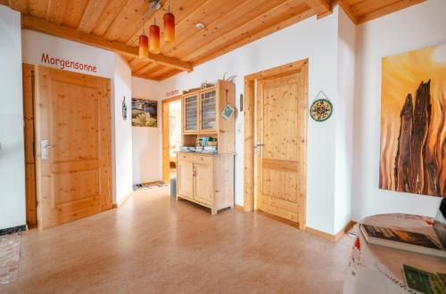 a large kitchen with wooden floors and a wooden ceiling at Prinzenhof in Grossgerungs