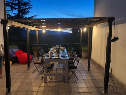 a table set up on a patio at night at Casa nel bosco, Appennino Tosco Emiliano in Camugnano