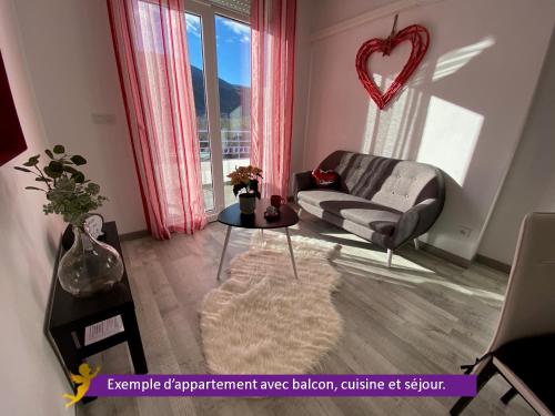 a living room with a couch and a table at Domaine des Anges in Amélie-les-Bains-Palalda