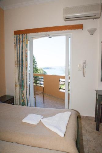 a bedroom with a bed and a view of the ocean at Meandros in Almirida