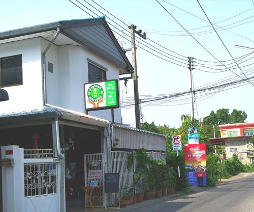 a restaurant with a sign on the side of a building at Ban Maitree in Chiang Mai