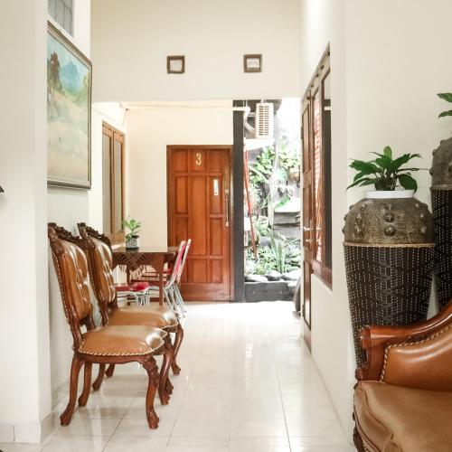 a hallway with chairs and a table in a house at The Homey Rooms and Tours in Yogyakarta