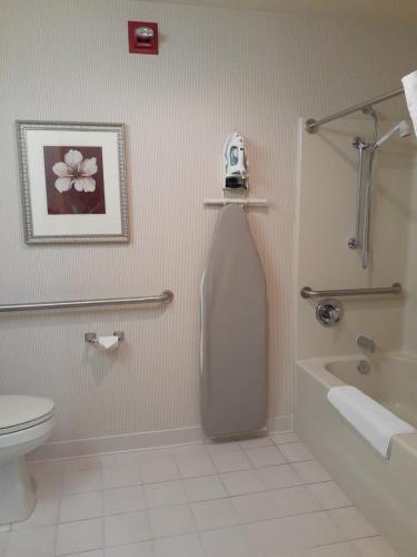 a bathroom with a toilet and a sink at Country Inn & Suites by Radisson, Freeport, IL in Freeport