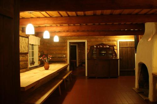 a wooden room with a bench and a kitchen at Miškiniškės in Ignalina
