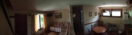 a living room with a bed and a window at Los Almendros in La Cumbre
